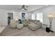 Bright living room featuring stylish furniture, a ceiling fan, and plenty of natural light from large windows at 8152 Seashell St, Englewood, FL 34224