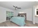 Serene main bedroom with a plush bed, neutral tones, and a sliding glass door at 8152 Seashell St, Englewood, FL 34224