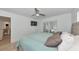Serene main bedroom with a comfortable bed, a ceiling fan, a sliding door to the lanai and lots of natural light at 8152 Seashell St, Englewood, FL 34224