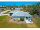Charming home with a patio area, lush landscaping, and a well-maintained lawn at 8152 Seashell St, Englewood, FL 34224