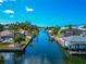 Picturesque waterfront view with lush landscaping, residential homes, and boat docks at 8152 Seashell St, Englewood, FL 34224