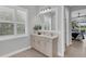 Bathroom with a white vanity, a decorative mirror and bright natural light at 8258 Grande Shores Dr, Sarasota, FL 34240