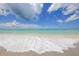 Beautiful beach scene with clear, shallow water, perfect for a relaxing day by the sea at 8258 Grande Shores Dr, Sarasota, FL 34240