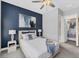 Bedroom featuring an accent wall, ceiling fan, and walk-in closet at 8258 Grande Shores Dr, Sarasota, FL 34240