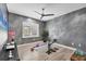 Bedroom with ample lighting, a textured gray wall, and wood laminate flooring at 8258 Grande Shores Dr, Sarasota, FL 34240