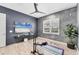 Bedroom featuring gray and blue walls, a ceiling fan, and wood laminate flooring at 8258 Grande Shores Dr, Sarasota, FL 34240