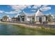 Stunning exterior view of a lakeside restaurant featuring outdoor seating and a serene waterfront setting on a beautiful day at 8258 Grande Shores Dr, Sarasota, FL 34240