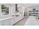 Modern kitchen with white cabinetry, stone countertops, and stainless steel appliances at 8258 Grande Shores Dr, Sarasota, FL 34240