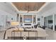 Open-concept living room with wood-look tile flooring, modern decor, and custom ceiling details at 8258 Grande Shores Dr, Sarasota, FL 34240