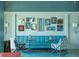 Inviting living room featuring a stylish blue sofa, patterned chairs, and unique wall art at 8258 Grande Shores Dr, Sarasota, FL 34240
