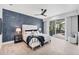 Modern main bedroom featuring an accent wall and patio access to the pool at 8258 Grande Shores Dr, Sarasota, FL 34240