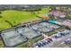 Expansive aerial view of community with tennis courts, golf course, driving range, clubhouse and pool at 8921 Veranda Way # 325, Sarasota, FL 34238