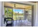 Relaxing screened balcony with neutral tile flooring overlooking the lush greenery and golf course at 8921 Veranda Way # 325, Sarasota, FL 34238