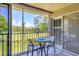 Inviting outdoor balcony with scenic golf course view and screened enclosure for relaxed seating at 8921 Veranda Way # 325, Sarasota, FL 34238