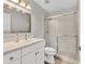 Modern bathroom with white vanity, large mirror, and glass enclosed shower at 8921 Veranda Way # 325, Sarasota, FL 34238