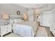Bright bedroom with ensuite bath features a large bed and neutral decor at 8921 Veranda Way # 325, Sarasota, FL 34238