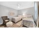 Cozy, neutral guest bedroom features twin beds, soft textures and modern ceiling fan at 8921 Veranda Way # 325, Sarasota, FL 34238