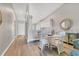 Dining room with a glass table and white wicker chairs, open to the kitchen and living areas at 8921 Veranda Way # 325, Sarasota, FL 34238