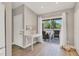 Inviting entryway with a decorative table, tiled floor, and sliding glass doors to screened outdoor seating area at 8921 Veranda Way # 325, Sarasota, FL 34238