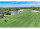 Aerial view of a beautiful golf course, lake, sand traps and lush green scenery at 8921 Veranda Way # 325, Sarasota, FL 34238