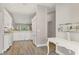 Hallway leading to kitchen featuring all-white appliances and decor at 8921 Veranda Way # 325, Sarasota, FL 34238