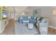 Bright and airy living room features wood floors, blue sectional, and stylish decor with plenty of space at 8921 Veranda Way # 325, Sarasota, FL 34238
