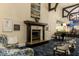 Comfortable living room featuring a fireplace, piano, beautiful furnishings and modern decor at 8921 Veranda Way # 325, Sarasota, FL 34238