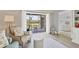 Comfortable seating area leads to a screened balcony with golf course views and bedroom entrance at 8921 Veranda Way # 325, Sarasota, FL 34238