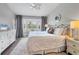 Comfortable main bedroom with large bay window, a ceiling fan, and stylish decor at 8921 Veranda Way # 325, Sarasota, FL 34238