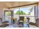 Relaxing screened patio with wicker chairs and table with a view of the outdoor scenery at 8921 Veranda Way # 325, Sarasota, FL 34238