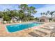 Outdoor swimming pool with comfortable lounge chairs in a peaceful setting at 8921 Veranda Way # 325, Sarasota, FL 34238