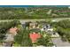 Aerial view of a luxury residential neighborhood featuring mature trees and scenic waterways at 901 Reflection Way, Osprey, FL 34229