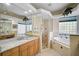 Bathroom with granite counters, glass block window, shower and garden tub at 901 Reflection Way, Osprey, FL 34229