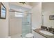 Bright bathroom with a glass-enclosed shower, granite counters, and sink at 901 Reflection Way, Osprey, FL 34229