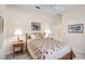 Bright bedroom with neutral color palette and ceiling fan at 901 Reflection Way, Osprey, FL 34229