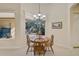 Breakfast nook with wood dining table set surrounded by natural light and views at 901 Reflection Way, Osprey, FL 34229