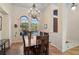 Formal dining room featuring wood floors, neutral paint, decorative lighting, a large window and ample space at 901 Reflection Way, Osprey, FL 34229