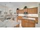 Well-lit kitchen with stainless steel appliances, custom cabinets, and granite countertops at 901 Reflection Way, Osprey, FL 34229