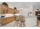 Eat-in kitchen featuring light wood cabinetry, a breakfast bar with seating, and recessed lighting at 901 Reflection Way, Osprey, FL 34229