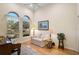 Cozy living room with hardwood floors, arched windows, and ample natural light at 901 Reflection Way, Osprey, FL 34229