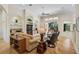 Bright living room with hardwood floors, neutral paint, built-in shelving, fan and sliding glass doors to the lanai at 901 Reflection Way, Osprey, FL 34229