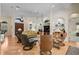 Comfortable living room with hardwood floors, neutral paint, decorative columns, display shelving and a ceiling fan at 901 Reflection Way, Osprey, FL 34229
