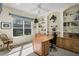 Bright office with built-in bookshelves, neutral carpet, and large window at 901 Reflection Way, Osprey, FL 34229