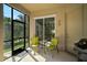 Screened-in patio with seating and grill at 901 Reflection Way, Osprey, FL 34229