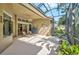 Screened-in patio with seating and view of the garden at 901 Reflection Way, Osprey, FL 34229