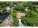 Aerial view of a home with a red tile roof, lush landscaping, and a pool at 919 80Th Nw St, Bradenton, FL 34209