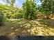 Expansive backyard featuring lush landscaping, mature trees, and a charming wood deck, perfect for outdoor entertaining at 919 80Th Nw St, Bradenton, FL 34209