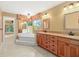 Bright bathroom showcasing a large soaking tub with garden views, complemented by elegant vanity with dual sinks at 919 80Th Nw St, Bradenton, FL 34209