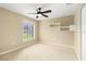Cozy bedroom featuring a ceiling fan, modern wall shelves, and a window offering natural light at 919 80Th Nw St, Bradenton, FL 34209