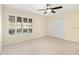 Bright bedroom featuring large windows with plantation shutters, a ceiling fan, and a spacious double-door closet at 919 80Th Nw St, Bradenton, FL 34209